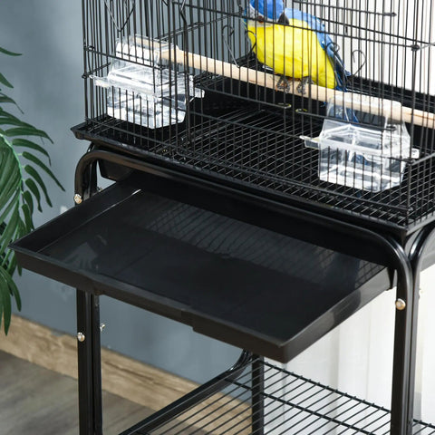 Heavy Duty Sixty Inch Metal Bird Cage With Easy Rolling Stand And Handy Storage Basket For Small Parrots Budgies Plus Full Pet Start Kit Accessories Ready To Treat Your Feathered Crew Black indoor view with pull out tray.