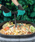 Hands using Built Tough Aerator Tool With Rotating Spiral For Outdoor Tumbler Bins And Bags Tall 33 Inch Stand Up Turner on compost pile
