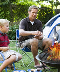 Father and son using 24 Inch Fire Pit Spark Screen with Foldable Hook and Marshmallow Sticks, Heavy Duty Steel Mesh Cover