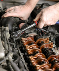 Mechanic using 100 Tooth Swivel Head Ratchet Set for heavy duty jobs on engine with chrome vanadium steel tool