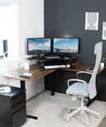 43 Inch Corner Electric Height Adjustable Desk Riser For Dual Monitors set up in a modern home office with dual monitors