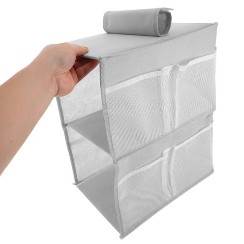 Layered Hanging Storage Bag Slick Nonwoven Closet Organizer With Roomy Pockets, gray fabric, hand holding the organizer, ideal for bathroom.
