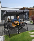 Man playing guitar on 3 seater porch swing with Heavy Duty Patio Swing Canopy Replacement Cover For 3 Seater Porch Swing, Grey.