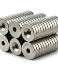Heavy Duty N50 Neodymium Countersunk Disc Magnets With Screw Secure Flush Mount Setup and Kickass Rare Earth Hold For Cabinets Drawers and Tool Boxes In A Tough 50 Pack stacked at an angle.
