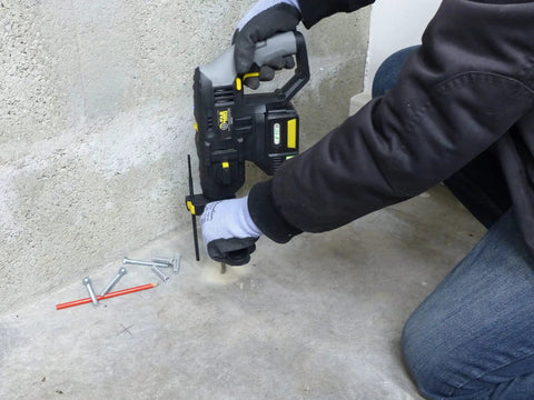 User operating an 18V Cordless Hammer Drill In Black, Beast Mode Action With Badass Durability on masonry.