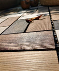 Close-up of Durable Wood Plastic Composite Patio Deck Tiles With Interlocking Design For 3D Random Pattern DIY Floor Tiles, outdoor setup.