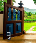 Spring Loaded Gate Caster With Hidden Spring Heavy Duty Fence Wheel 75Kg Load on a wooden gate in a lush outdoor setting.