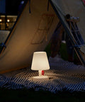Tiny Rechargeable LED Lamp 2.0 Go Anywhere Dimmable Table Light glowing inside a tent at night, ideal for indoor and outdoor use