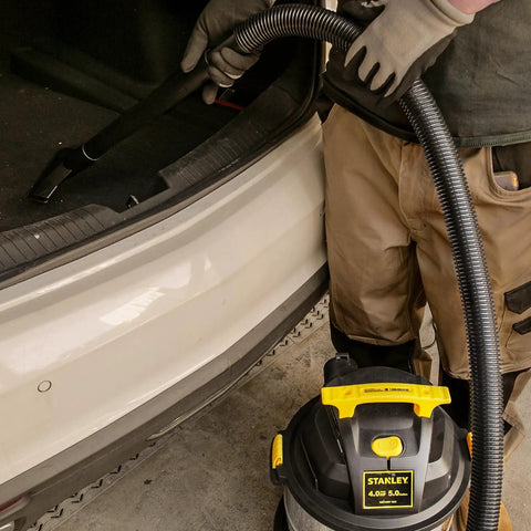 Beast Of A 5 Gallon Wet Dry Shop Vacuum With 4 Peak HP Motor Stainless Steel Tank Portable Vac in use at car trunk