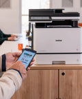 Color Laser All In One Printer With Duplex Printing, Scan And Copy, Fast 33 Pages Per Minute, Budget Friendly Per Page Printing, Compact Durable Design, Advanced Security Features For Busy Offices on a desk