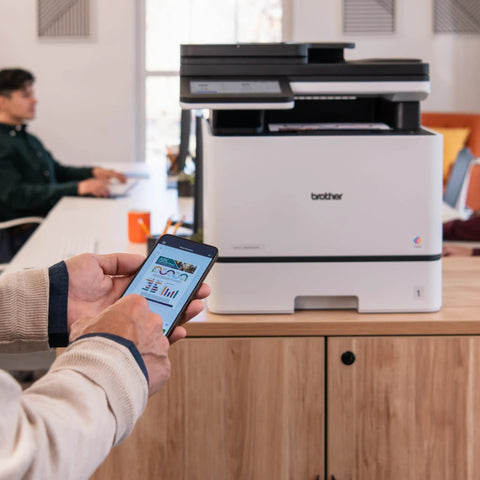 Color Laser All In One Printer With Duplex Printing, Scan And Copy, Fast 33 Pages Per Minute, Budget Friendly Per Page Printing, Compact Durable Design, Advanced Security Features For Busy Offices on a desk