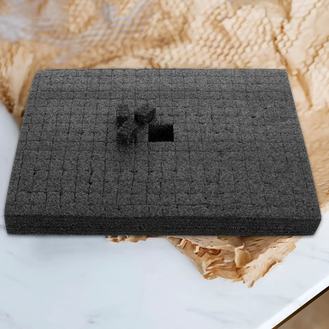 Custom Cut Black Packing Foam Insert Pad Rock Solid Cushion Block Super Useful For Shipping Moving Gear Around Without A Hitc on a table.