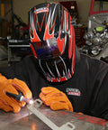 Person welding with protective helmet and gloves, wearing Black Flame-Resistant 9 Oz Cotton Welding Jacket Delivers Breathable Comfort, Large Size, Shields Arms And Torso From Spatter And Heat, Snap Cuffs For A Snug Fit, Internal Pocket For Safe Storage, Tough As Nails Weld Gear For Daily Use