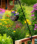 Hella Durable Expandable Deck Hook With A Two Inch Non Slip Railing Mount holding a flower basket in a colorful garden.