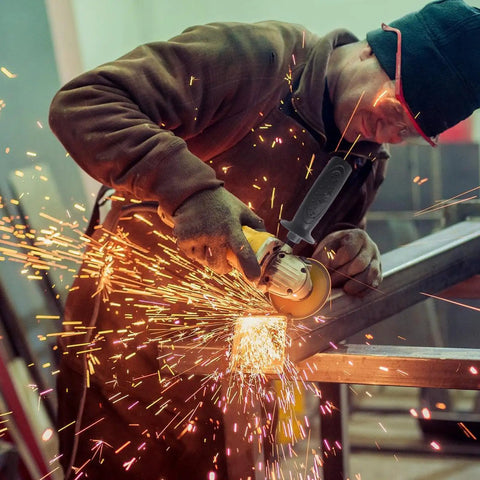 Worker using angle grinder with Heavy Duty Secondary Side Handle For Angle Grinders featuring Dead Tough Build and Hella Solid Non Slip Grip.