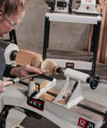 Woodworker using 12 By 21 Inch Variable Speed Woodworking Lathe With 1 HP 115V 1 Phase Three RPM Ranges 60 to 900 110 to 1800 220 to 3600 Ratchet Belt Tension System Big DRO Recessed Power Switch