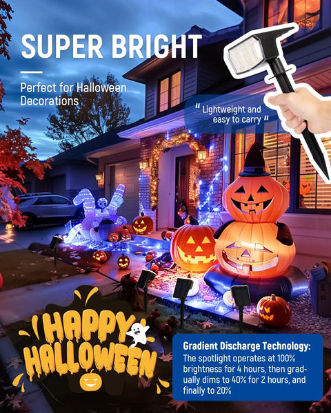 Top Shelf Kickass Outdoor Solar Spotlight Lights 4 Pack illuminating Halloween decorations with pumpkins in a front yard.