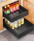 Heavy Duty Slide Out Cabinet Organizer Full Extension Roll Out Shelf With Super Smooth Glide And No Fuss Nano Tape Under Sink Pantry Storage For Kitchen And Bathroom Black with cans and bottles.