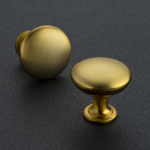 Premium Zinc Cabinet Knobs Featuring A Killer Gold Finish And Fresh Euro Style Vibe Built Different For Long Lasting Performance A Straight Up Quality 30 Pack Furniture Hardware Refresh, two brushed gold knobs on dark surface.