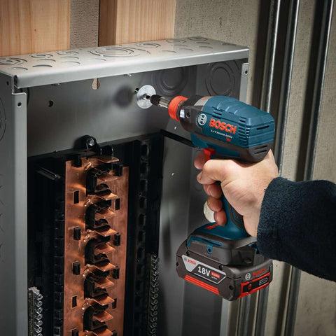 Side view of Bosch cordless impact driver with Phillips #2 bit installed, driving into a copper electrical panel.