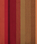 Colorful fabric pattern showcasing fade-resistant Brazilian hammock material with red and brown stripes.