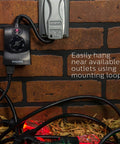 Outdoor Light Sensing Plug In Mechanical Timer With Dual Polarized Outlets For Yard And Patio Lighting mounted on a brick wall.
