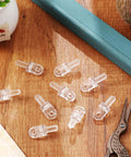 Hella Durable 6-Pack Horizontal Blind Wand Replacement Parts, clear plastic wand tips on wood surface for easy repairs.