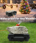 Heavy Duty Outdoor Electrical Box With Tough As Nails IP54 Rain Cover on a grassy area with a rock and holiday lights.