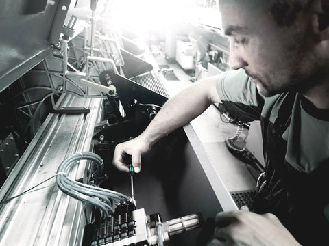 Technician using Kraftform Micro 2035 Slotted Electronics Precision Screwdriver with 2mm Tip in control panel assembly.