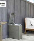 Weatherproof 17.3 Gallon Wicker Storage Box With Slatted Acacia Wood Flip Top next to outdoor sofa on patio