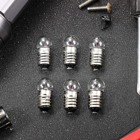 6 E10 miniature screw light bulbs 2.5V 0.3A on black background, ideal for model cars and circuits, compact warm glow.