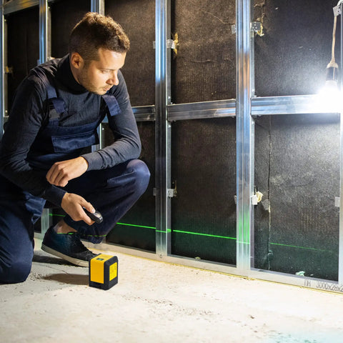 Versatile Laser Level With Horizontal Vertical And Cross Line Beams For Picture Hanging And DIY Home Renovation, 59 Foot Range Green Laser, Auto Pendulum Mode And Manual Option, Class II Indoor Outdoor, Yellow And Black, used by man during wall installation