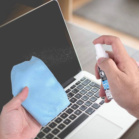 Lens and screen cleaning kit with blue microfiber cloth and spray bottle used on laptop screen
