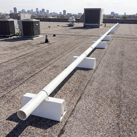 Eight Pack Six Inch Pvc Pipe Support Blocks Non Penetrating Rooftop Conduit Stand Pre Cut Ready To Use For Water Gas Electrical And Refrigeration Lines Hassle Free Setup on a rooftop with pipes.