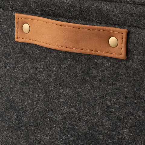 Close-up of Hella Spacious Rectangular Felt Storage Basket With Faux Leather Handles, showing gray felt and tan leather handle.