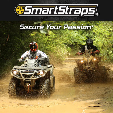 Two people riding ATVs through mud in a forest with 'SmartStraps' logo and 'Secure Your Passion' text above.