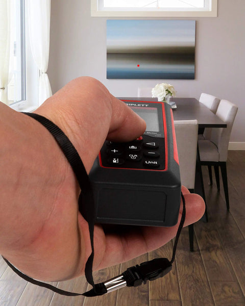 Hand holding Boss Level Precision 230 Ft Laser Distance Meter With Volume Calculation Pythagorean Mode And Stakeout Layout Angle Display.
