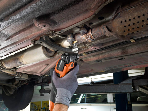 Rugged Starlock Oscillating Multitool Carbide Blade cutting through metal in tight vehicle space for demolition projects.