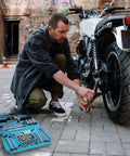 Mechanic using tools from 2-Piece Silicone Tool Tray Set With Non-Slip Flexible Organizer And Magnetic Tray Large Capacity on motorcycle