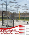 Ballpark Ready Batting Cage Repair Kit Features Thirty Sets Of One Point Seven Five Inch Red Nylon Pulleys Paired With Quarter Inch Spring Hooks For Hard Working Fields in a batting cage.
