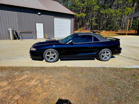 Top Shelf Tinted Blue Paint Basecoat Gallon Ready To Spray With Slow Reducer Blend For Ultra Smooth Automotive Finish That Hits Perfect And Looks Totally Fresh On Any Ride on a black convertible car.