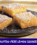 Gluten-free lemon squares with powdered sugar on a black plate, highlighting Gluten Free Pancake And Baking Mix For Fluffy Pancakes.