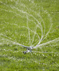Heavy Duty Spinning Sprinkler With Wheeled Base For 360 Degree Coverage In Flower Beds And Vegetable Gardens, Metal Whirling Head Delivers Gentle Rain Like Spray, Reduces Water Pooling, Easy Move Across Lawn spraying water on grass