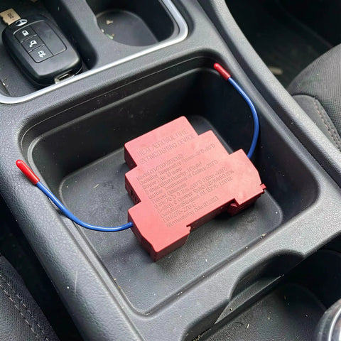 Automatic Fire Extinguishing Device Dual Line Aerosol 10 Gram Pair in a car cup holder, designed for fire suppression with no power required.