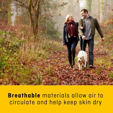 Couple walking dog in forest promotes Ankle Comfort Support Sleeve with mild compression and breathable material for dry skin