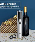 Cordless Electric Wine Opener With Automatic Cork Extractor And Precision Foil Cutter With Rechargeable Base next to a wine bottle and gift-wrapped presents.