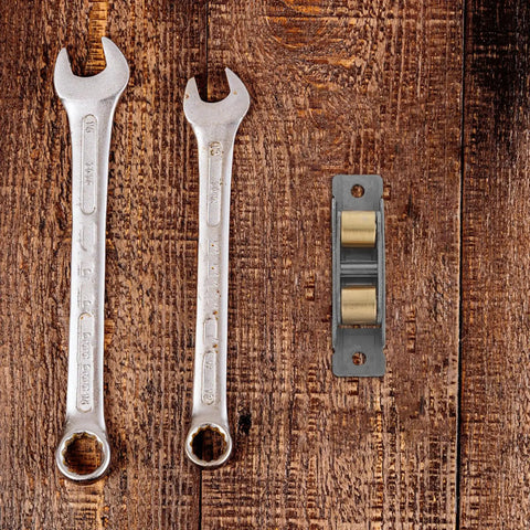 Upgrade Your Sliding Door Game Today With These Heavy Duty Stainless Steel Double Wheel Track Rollers and tools on wood background.