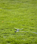 Heavy Duty Spinning Sprinkler With Wheeled Base For 360 Degree Coverage In Flower Beds And Vegetable Gardens on grassy lawn