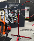 Pro Truing Stand With Thru Axle Adapter Compact Portable Aluminum Single Arm Design for Repair Stand, supporting bike wheel.