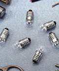 50 Pack E10 Miniature Screw Base Light Bulbs 3.8 Volt 0.3 Amp Mini Pilot Lamps showing six bulbs on a silver background.